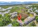 Aerial view of a coastal community with a red marker, highlighting the proximity to water and lush landscaping at 140 South Cove Pl. # 6C, Pawleys Island, SC 29585
