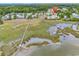 Aerial view showcasing the community, marsh, and private dock access for residents at 140 South Cove Pl. # 6C, Pawleys Island, SC 29585