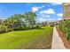 Lush green backyard offers a pathway and views of neighboring buildings, creating a sense of community at 140 South Cove Pl. # 6C, Pawleys Island, SC 29585