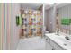 Whimsical bathroom with colorful striped wallpaper, a shower with themed curtains, and updated fixtures at 140 South Cove Pl. # 6C, Pawleys Island, SC 29585