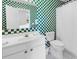 Modern bathroom featuring green and white checkerboard tiling, a vanity, and a toilet at 140 South Cove Pl. # 6C, Pawleys Island, SC 29585