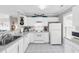 Bright kitchen featuring white appliances and cabinets, as well as light-colored tile flooring at 140 South Cove Pl. # 6C, Pawleys Island, SC 29585