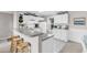 Well-lit kitchen featuring white cabinets, a gray countertop, breakfast bar, and modern appliances at 140 South Cove Pl. # 6C, Pawleys Island, SC 29585