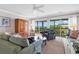 Bright living room with sliding glass doors opening to a deck with gorgeous golf course views at 140 South Cove Pl. # 6C, Pawleys Island, SC 29585