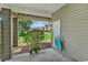 Covered patio area with a door, potted plants, and outdoor chairs, creating a cozy outdoor retreat at 140 South Cove Pl. # 6C, Pawleys Island, SC 29585