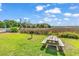 Community picnic area features a wooden table, barbecue grill, and green lawn with views of a marshland at 140 South Cove Pl. # 6C, Pawleys Island, SC 29585