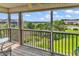 Relaxing screened porch with views of lush landscaping, a community pool and neighboring buildings at 140 South Cove Pl. # 6C, Pawleys Island, SC 29585