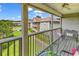 Relaxing screened porch with views of lush landscaping, a community pool and neighboring buildings at 140 South Cove Pl. # 6C, Pawleys Island, SC 29585