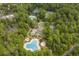 Overhead view of community pools and tennis courts surrounded by lush greenery, perfect for recreation and relaxation at 1401 Lighthouse Dr. # 4334, Little River, SC 29566