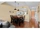 Inviting dining area with a large wooden table, pendant lighting, and a view of the open-concept kitchen at 1401 Lighthouse Dr. # 4334, Little River, SC 29566