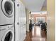 Hallway view of the laundry area with full size stackable washer and dryer at 1401 Lighthouse Dr. # 4334, Little River, SC 29566