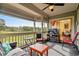 Relaxing screened porch with comfortable seating and a view of the lush, green landscape at 1401 Lighthouse Dr. # 4334, Little River, SC 29566