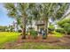 Backyard view with mature landscaping, outdoor seating, and a glimpse of neighboring balconies at 1413 Cottage Cove Circle, North Myrtle Beach, SC 29582
