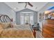 Charming bedroom featuring a bay window with plantation shutters, a comfortable chair, and a ceiling fan at 1413 Cottage Cove Circle, North Myrtle Beach, SC 29582