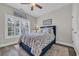 Cozy bedroom featuring a blue bed, hardwood floors, and natural light from the window at 1413 Cottage Cove Circle, North Myrtle Beach, SC 29582