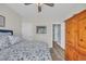 Cozy bedroom with ceiling fan, wood-look floors, and comfortable bed with leaf-patterned bedding at 1413 Cottage Cove Circle, North Myrtle Beach, SC 29582