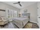 Comfortable bedroom with wood-look floors, a ceiling fan, and a large window with plantation shutters at 1413 Cottage Cove Circle, North Myrtle Beach, SC 29582