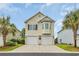 Charming two-story home with double garage and tropical landscaping in a sunny neighborhood at 1413 Cottage Cove Circle, North Myrtle Beach, SC 29582