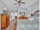 The primary bedroom features a wooden dresser, TV, ceiling fan, and ensuite bathroom access at 1413 Cottage Cove Circle, North Myrtle Beach, SC 29582