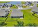 Aerial view of a home with a backyard, patio, and waterfront views of a community lake at 1520 Jardine Loop, Little River, SC 29566