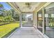 Relaxing screened porch features ceiling fan, swing, and views of the backyard at 1520 Jardine Loop, Little River, SC 29566