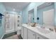 Ensuite bathroom boasts double sinks, large mirror, and a glass-enclosed shower at 1520 Jardine Loop, Little River, SC 29566