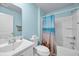 Bathroom featuring a tub and shower combination with beach themed shower curtain and a white single sink vanity at 1520 Jardine Loop, Little River, SC 29566