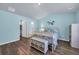 Light-filled bedroom features a colorful color palette, hardwood floors, and access to the ensuite bathroom at 1520 Jardine Loop, Little River, SC 29566