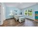Charming bedroom features a cheerful color palette, hardwood floors, and ample natural light at 1520 Jardine Loop, Little River, SC 29566