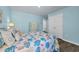 Bedroom featuring coastal decor, a bed with decorative pillows, and a dresser against light blue walls with wood-look flooring at 1520 Jardine Loop, Little River, SC 29566