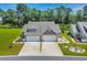 Charming home with two-car garages, a landscaped front yard, and a well-manicured lawn at 1520 Jardine Loop, Little River, SC 29566