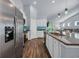 Bright kitchen with stainless appliances, granite counters, tile backsplash, and an island open to the living area at 1520 Jardine Loop, Little River, SC 29566