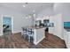 Bright kitchen featuring a central island with seating and stainless steel appliances at 1520 Jardine Loop, Little River, SC 29566