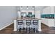 Bright kitchen featuring an island with granite counters, a tile backsplash, and stainless steel appliances, with barstool seating at 1520 Jardine Loop, Little River, SC 29566