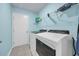 Laundry room with front load washer and dryer, white wire shelving, and tiled floors at 1520 Jardine Loop, Little River, SC 29566