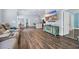 Open-concept living room boasts hardwood floors, comfortable seating, and abundant natural light at 1520 Jardine Loop, Little River, SC 29566