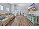 Spacious open-plan living area with comfortable seating, dining area, and a modern kitchen at 1520 Jardine Loop, Little River, SC 29566