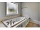 Relaxing bathroom with a large soaking tub and decorative tile at 1613 James Island Ave., North Myrtle Beach, SC 29582