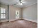 A spare bedroom has neutral carpet and is naturally lit with an outdoor access point at 1613 James Island Ave., North Myrtle Beach, SC 29582