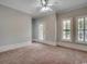 Spacious bedroom featuring neutral carpet, and natural light from windows with white trim at 1613 James Island Ave., North Myrtle Beach, SC 29582