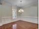 Bright dining room with hardwood floors, detailed trim, and an elegant chandelier at 1613 James Island Ave., North Myrtle Beach, SC 29582