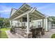 Inviting outdoor kitchen with a built-in grill, bar seating, and a covered pergola at 1613 James Island Ave., North Myrtle Beach, SC 29582