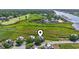 Overhead view of an idyllic home surrounded by scenic marshland, a golf course, and nearby waterways at 1663 Harbor Dr., North Myrtle Beach, SC 29582