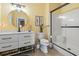 Bright yellow bathroom with round mirror and walk-in shower at 1663 Harbor Dr., North Myrtle Beach, SC 29582