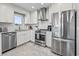Well-lit kitchen features stainless steel appliances, white cabinets, and a patterned tile backsplash at 1663 Harbor Dr., North Myrtle Beach, SC 29582