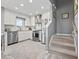 Bright, renovated kitchen with stainless appliances, white cabinetry, and stylish tile backsplash near stairs at 1663 Harbor Dr., North Myrtle Beach, SC 29582