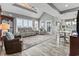 Bright living room boasts vaulted ceilings, a ceiling fan, and big windows with views of the outdoors at 1663 Harbor Dr., North Myrtle Beach, SC 29582