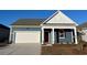Charming single-Gathering home with a two-car garage and a beautifully landscaped front yard at 173 Dagger Ct., Myrtle Beach, SC 29588