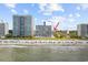 Beautiful beach and ocean view with high-rise resort in the distance at 2000 S Ocean Blvd. # V405, Myrtle Beach, SC 29577