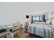 Bedroom with two beds, tv, dresser, dining area, and ocean view at 2000 S Ocean Blvd. # V405, Myrtle Beach, SC 29577